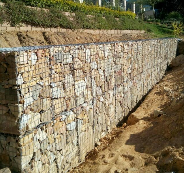 Gabion baskets are galvanized steel, twisted, woven wire mesh filled with stone for a variety of applications including, but not limited to, retaining walls, slope paving, drop structures, weirs, drop structures, and streambank protection.
